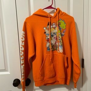 A Orange Nickelodeon Jacket With a Hoodie with all the Characters